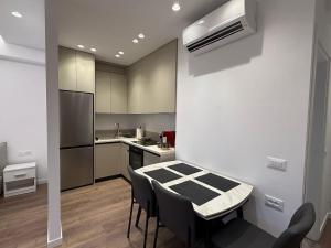 a kitchen with a table and chairs in a room at Riviera Central Escape in Sarandë