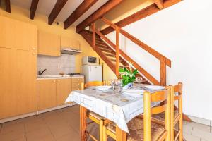 a kitchen with a table and chairs in a room at Duplex N°6 - Résidence Balnéaire in Le Port-des-Barques +13 photos