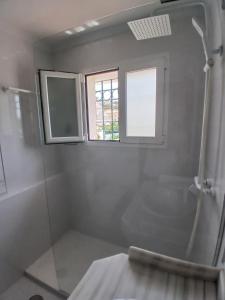a bathroom with a shower and a window at Casa Lunamar in Rincón de la Victoria +13 photos