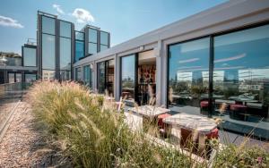 a building with windows and tables on the roof at Mandarin Oriental Mayfair, London in London