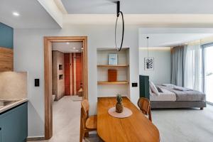 a room with a dining table and a bedroom at Merivian Seaside Suites in Kanali +19 photos