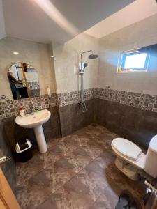 a bathroom with a sink and a toilet and a shower at White Villa Airport Transit Hotel in Katunayaka +240 photos