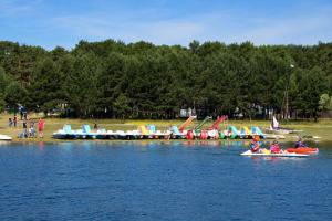 a group of people in kayaks on a body of water at Kampaoh Picos de Urbión in Abejar