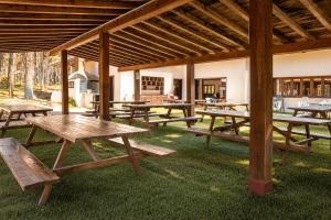 a group of picnic tables under a pavilion at Kampaoh Picos de Urbión in Abejar +41 photos