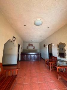 an empty waiting room with benches and a waiting room at Executive Manica Hotel in Chimoio