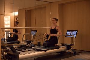 a woman riding on exercise bikes in a gym at Mandarin Oriental Mayfair, London in London +81 photos