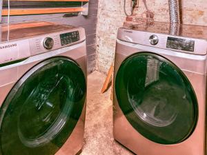 a washing machine sitting next to a washer at YLD Rooms - Shared Bathrooms & Spaces in Springfield