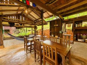 a dining room with a wooden table and chairs at Indigo Homestay in Ban Huai Pong