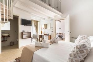 a white bedroom with a large white bed in a room at Domus Sagari in Presicce