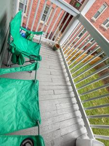 two green lawn chairs on a patio next to a staircase at YLD Rooms - Shared Bathrooms & Spaces in Springfield