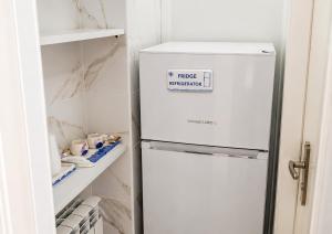 a white refrigerator with a sign on it in a kitchen at Casa Mare con finestra su balcone in Polignano a Mare