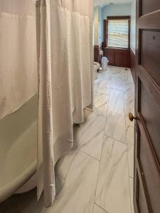 a bathroom with a shower and a tub and a toilet at YLD Rooms - Shared Bathrooms & Spaces in Springfield +27 photos