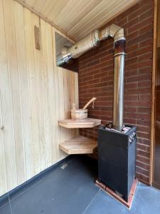 a wood stove sitting inside of a brick wall at Dilijan House in Dilijan