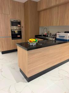 a kitchen with a bowl of fruit on a counter at appartement de luxe tanger in Tangier