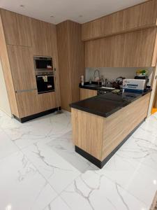 a kitchen with wooden walls and a counter top at appartement de luxe tanger in Tangier