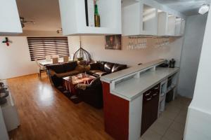 a kitchen and living room with a couch and a table at The Red Lounge in Strumica +6 photos