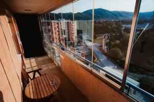a balcony with a chair and a view of a city at The Red Lounge in Strumica