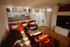 a living room with a leather couch and a bar at The Red Lounge in Strumica