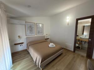 a bedroom with a bed and a sink and a mirror at Villa Anté B&B in Angri