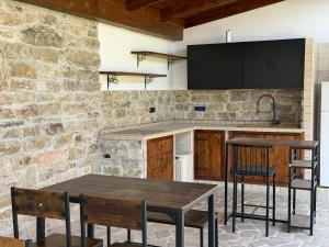 a kitchen with two wooden tables and a tv on a wall at Villa Anté B&B in Angri