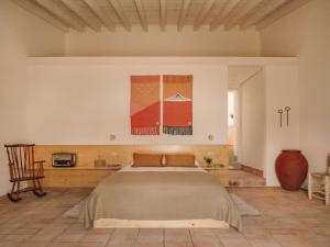 a bedroom with a large bed in a room at Casa Dez - Pedrogão do Alentejo in Pedrógão
