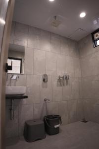 a bathroom with a sink and a toilet and a shower at Hotel Emirest in Bhilad