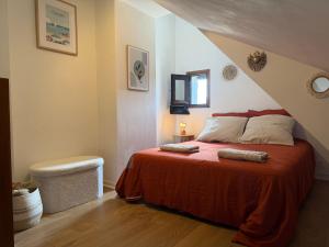 a bedroom with a bed with a red blanket at Le Cottage D'Ilona in Blonville-sur-Mer +6 photos