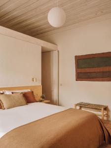 a bedroom with a bed and a wooden ceiling at Casa Dez - Pedrogão do Alentejo in Pedrógão +23 photos