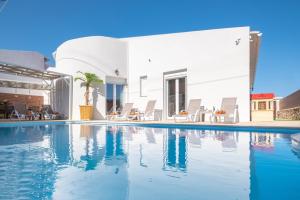 a swimming pool in front of a house at Sea Memories Villa in Skaleta