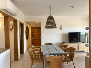 a kitchen and dining room with a table and chairs at Balaia Plaza in Albufeira