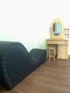 a black bed in a room with a mirror at Solar Tower in Soc Trang