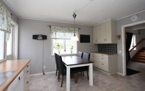 a kitchen with a table and chairs in a room at Villa Oakfield in Fröseke
