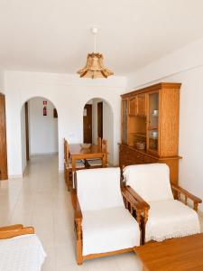 a living room with two chairs and a table at Apartamentos Carteia in Quarteira