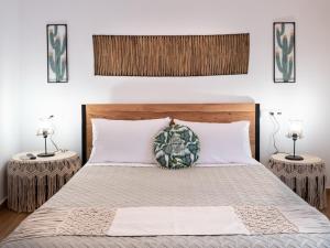 a bedroom with a large bed with two lamps at Sea Memories Villa in Skaleta +56 photos