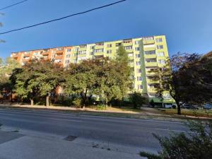 an empty street in front of a large building at LV Central Apartment in Levice