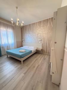 a bedroom with a bed in the middle of a room at Mar ricco Room 5 in Chioggia