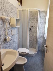 a bathroom with a shower and a toilet and a sink at Mar ricco Room 5 in Chioggia