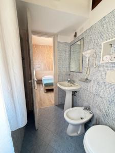 a bathroom with a white toilet and a sink at Mar ricco Room 5 in Chioggia