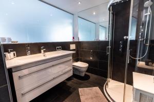 a bathroom with a sink and a toilet and a shower at Pension Ferienwohnung Pirhofer in Kramsach +186 photos