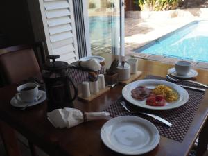 a table with a plate of food on top of it at Keiskama B & B in Port Elizabeth