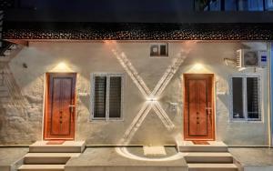 a house with two doors on the side of it at Hampi Tribes Homestay in Hampi