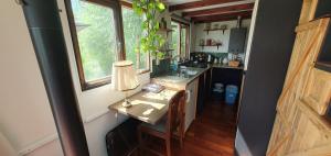 a kitchen with a table with a lamp on it at Tiny House Lau at Glamping Verbaarum in Bedum