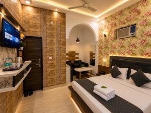 a bedroom with a bed and a living room at Hotel The Montana Suite - Free Airport and Aerocity Pickup & Drop in New Delhi
