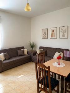 a living room with a couch and a table at Beachside Apartments Smajlaj in Velipojë