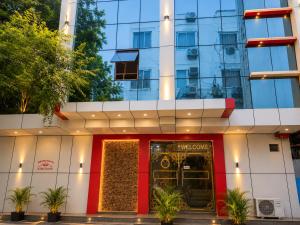 a hotel with a red door in front of a building at Hotel The Montana Suite - Free Airport and Aerocity Pickup & Drop in New Delhi