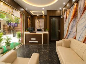 an office lobby with a couch and a desk at Hotel The Montana Suite - Free Airport and Aerocity Pickup & Drop in New Delhi