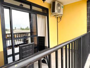 a balcony with a table and a chair and a window at Immeuble paco in Douala