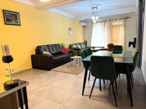 a living room with a table and a couch at Immeuble paco in Douala