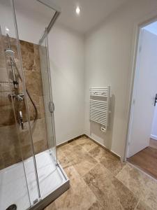 a bathroom with a shower with a glass shower stall at Résidence Terminus - appartements in Sainte-Maxime +46 photos