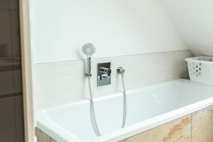 a shower in a bathroom with a tub at VINCENT Loft in der Innenstadt - mit Garage in Bregenz +22 photos
